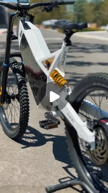 Close-up of the gold Ohlins suspension fork on an arctic white HPC Revolution electric bike