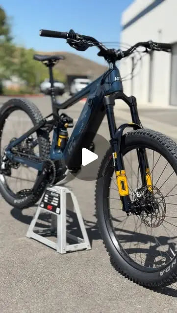 Custom midnight blue and black HPC Trailblazer enduro e-bike on a work stand