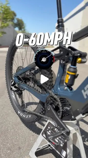 HPC Trailblazer e-enduro mountain bike on a stand with a 0-60 mph speedometer graphic
